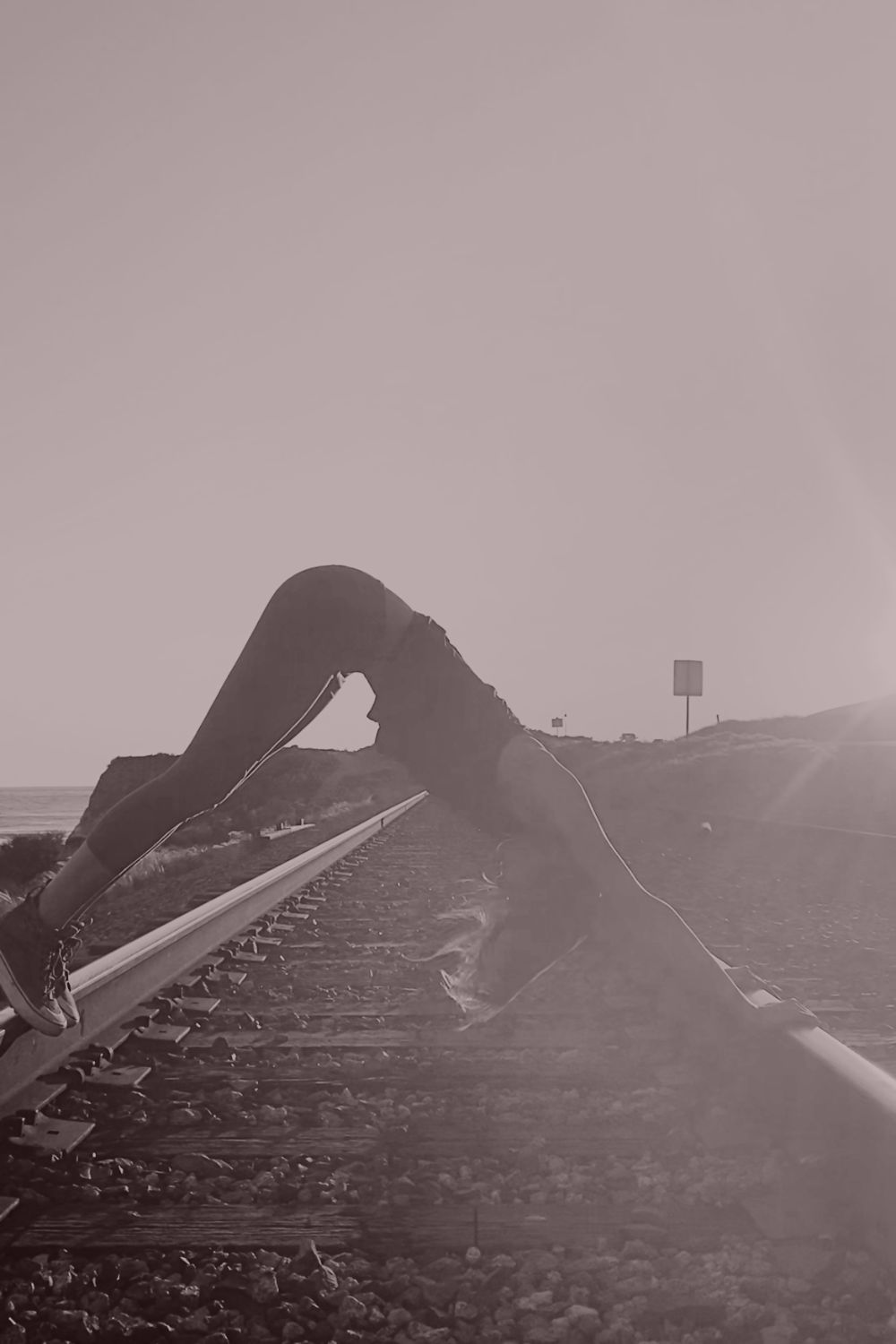 A backbend practiced along a quiet railway, an image of alignment