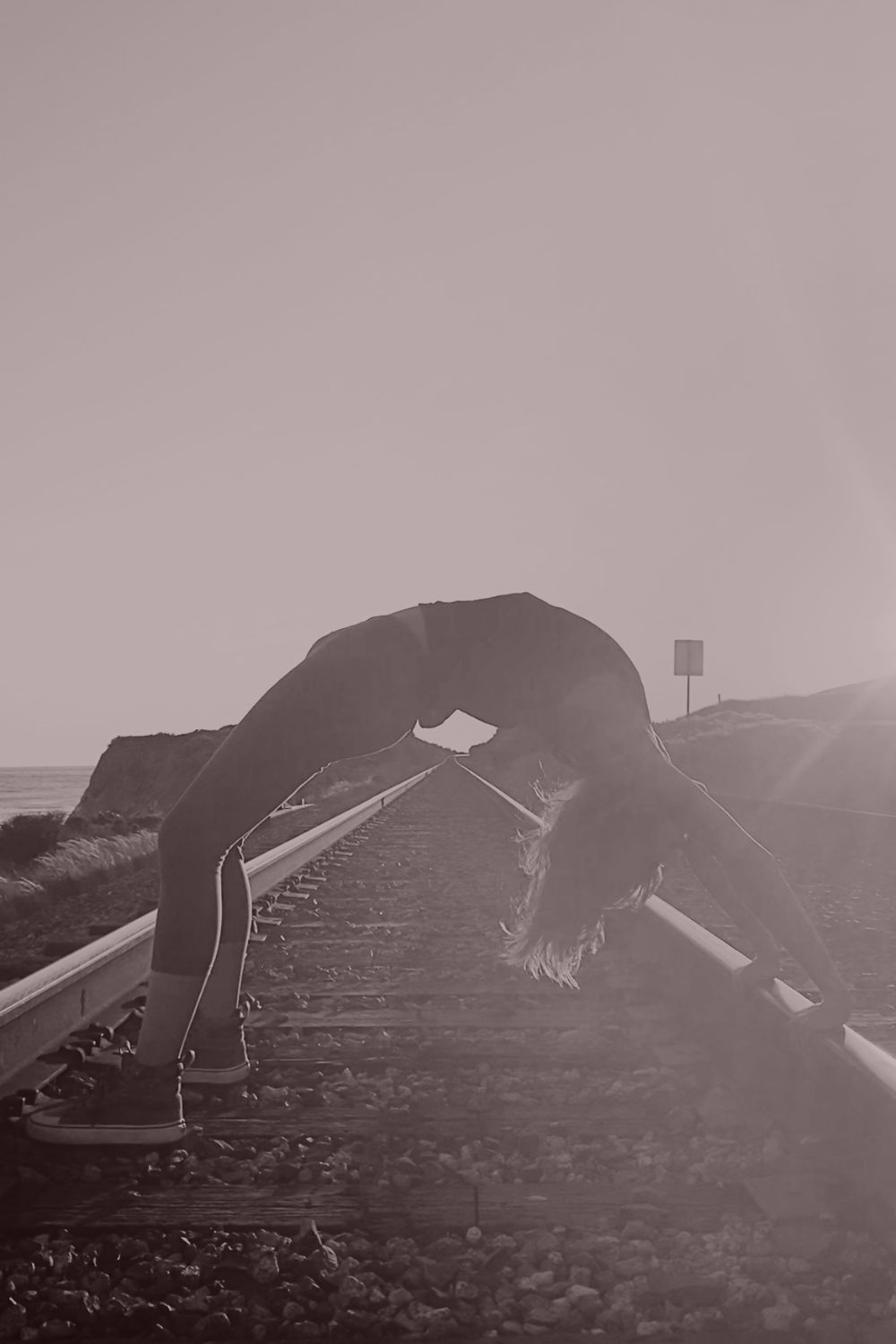 A full backbend along a quiet railway, literally a bridge