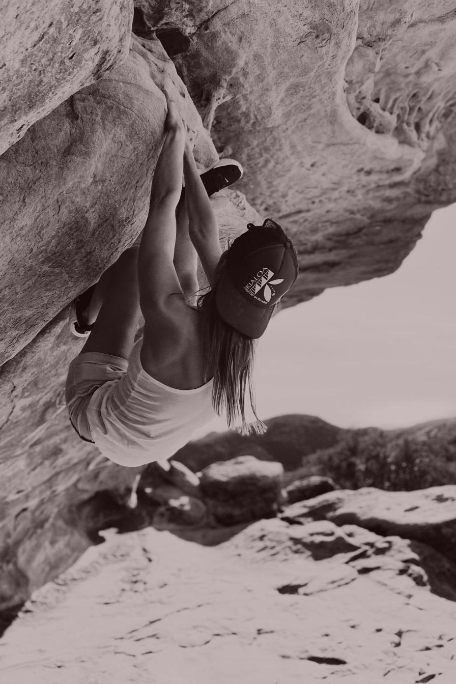 Rock climbing an overhang, hanging upside down