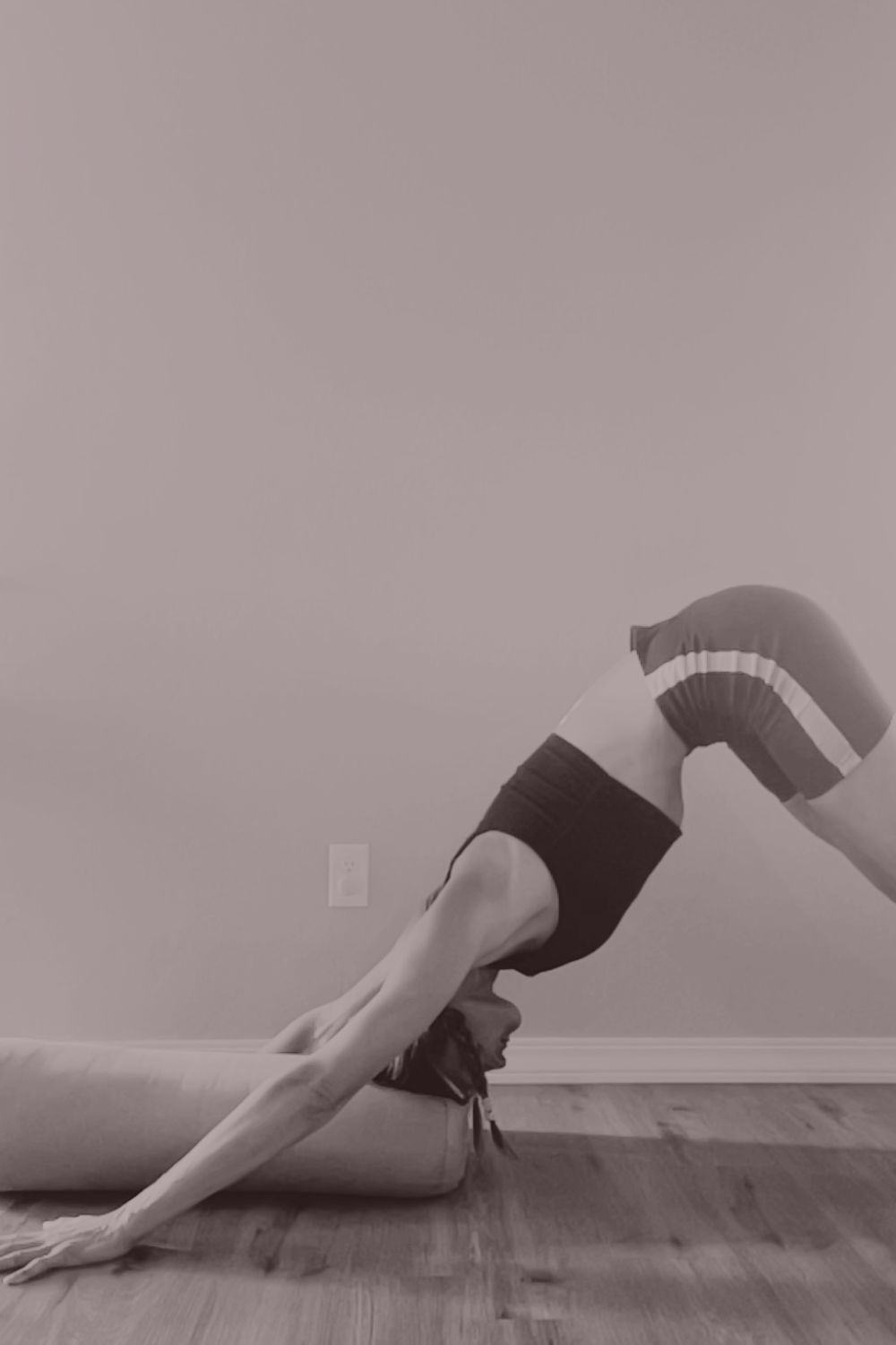 A supported downward dog using a bolster