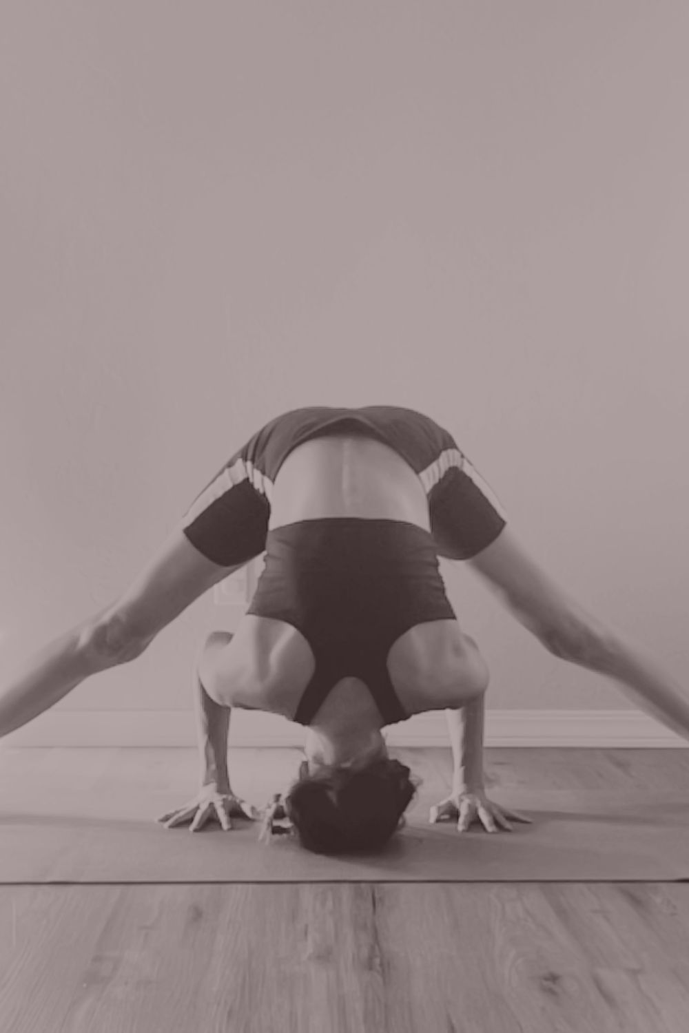 A wide-legged forward bend, an image of quiet surrender