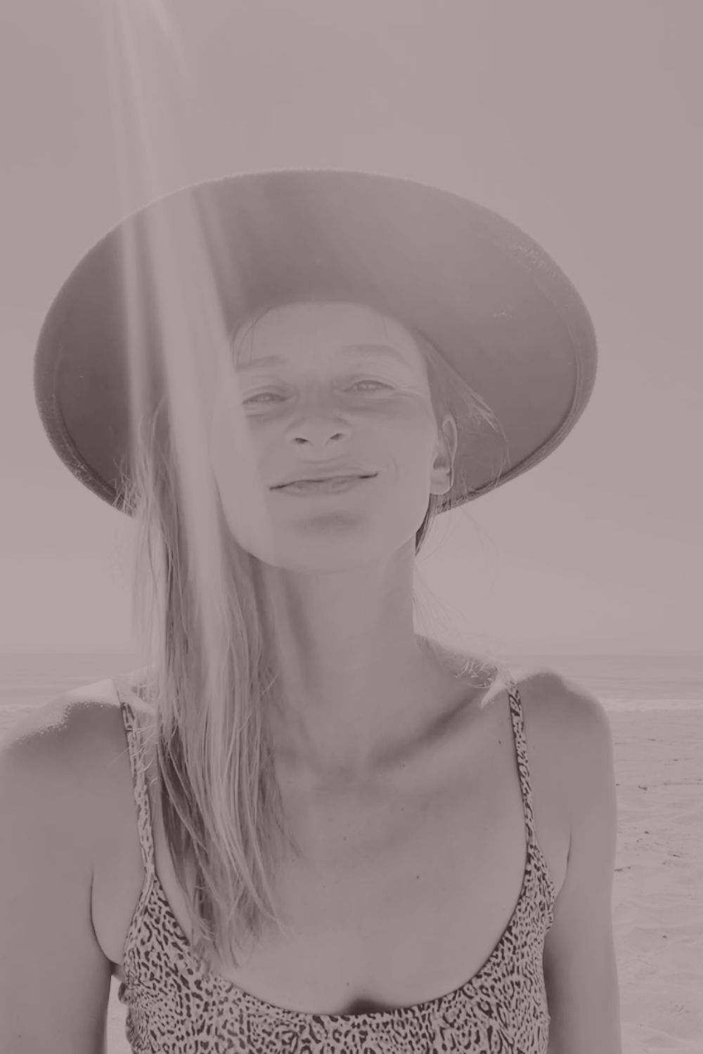 Rita smiling in the sunshine at the beach